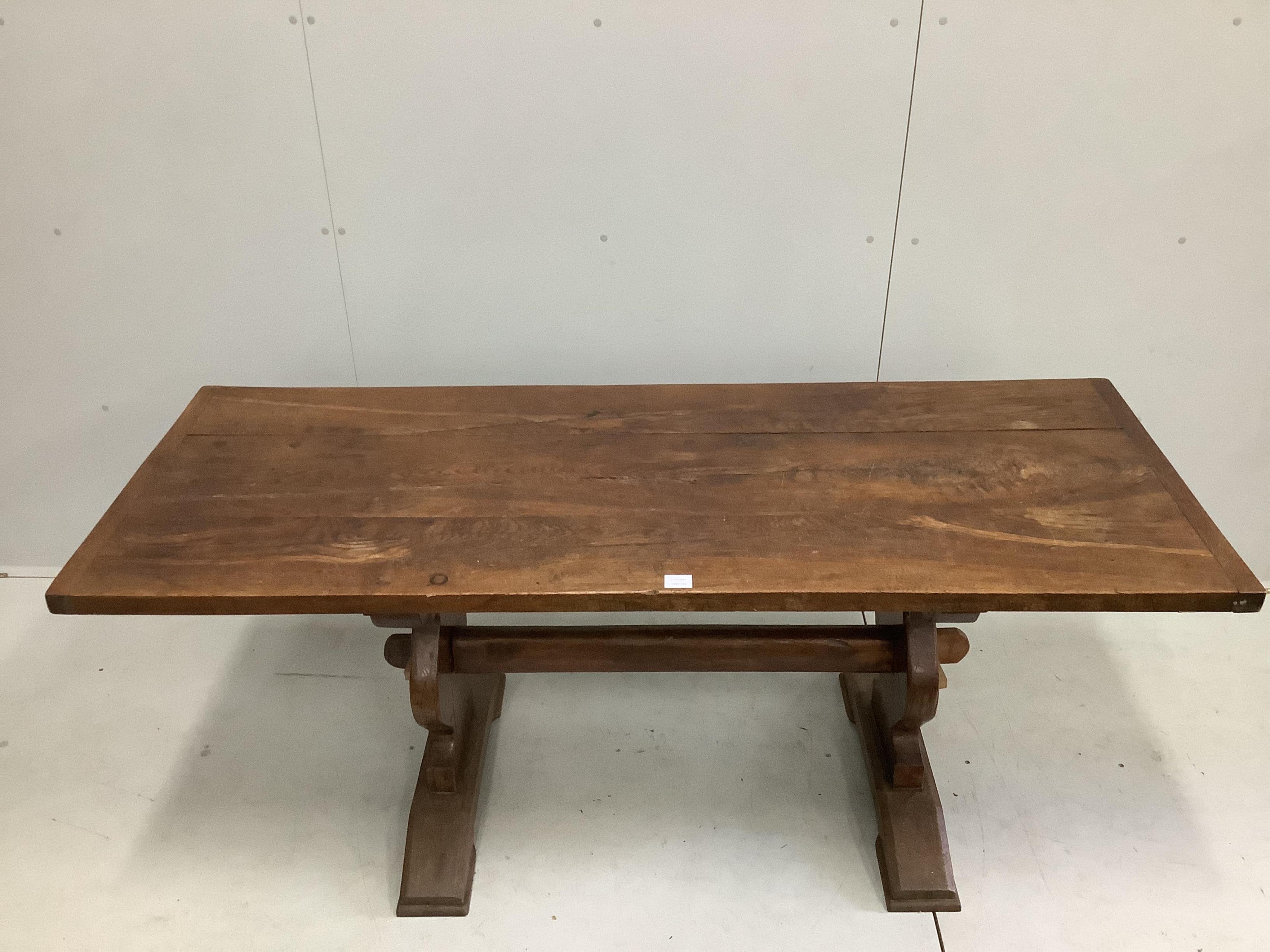 An 18th century style rectangular oak refectory dining table, on shaped end standards, width 176cm, depth 68cm, height 74cm. Condition - fair